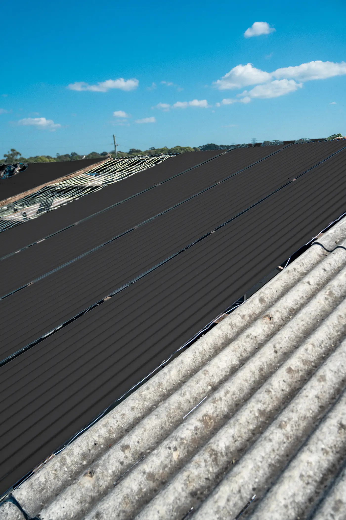 New roof sheets on an AD Roofing job, previewed in Monument® COLORBOND®