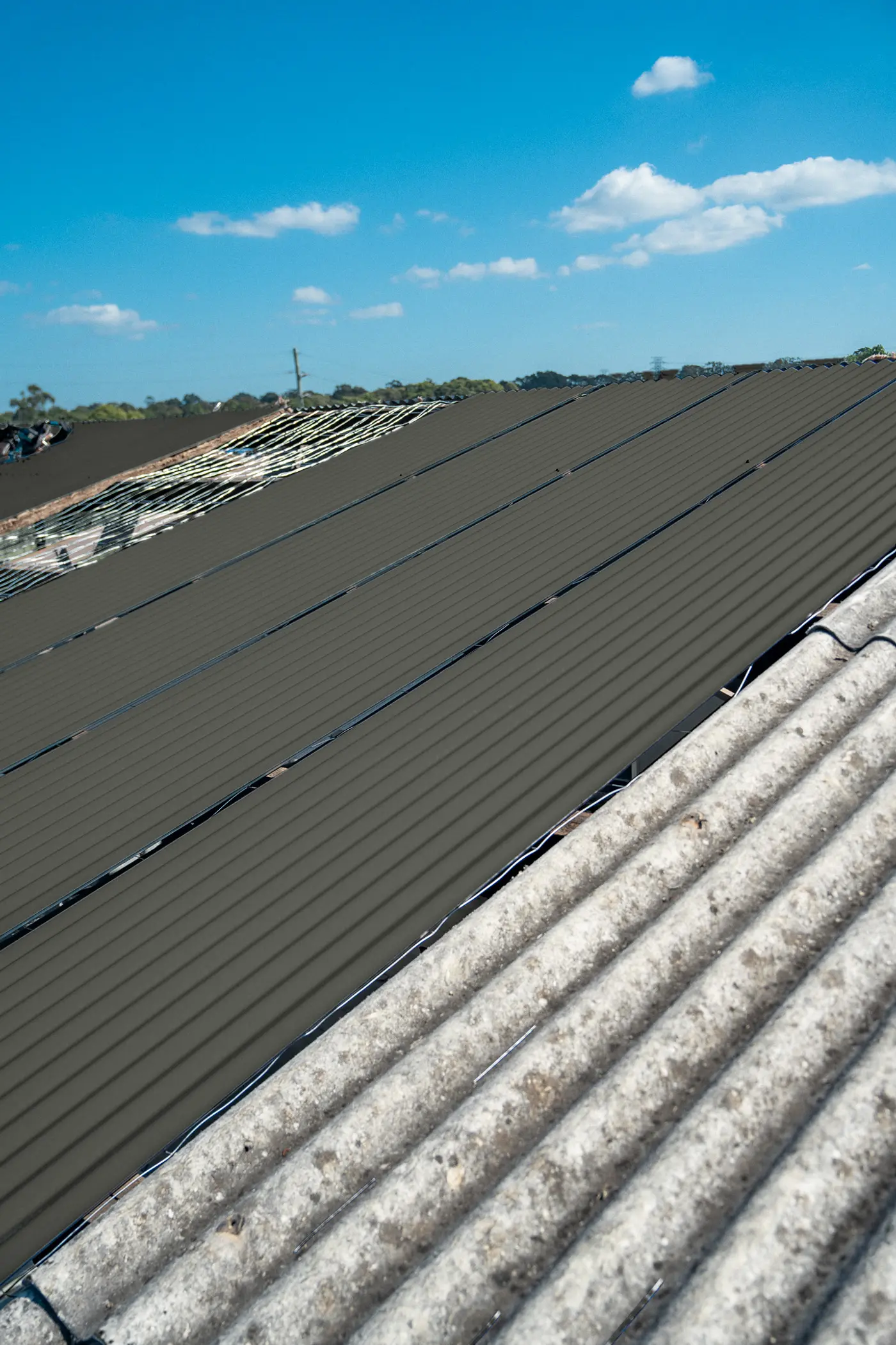 New roof sheets on an AD Roofing job, previewed in Woodland Grey® COLORBOND®
