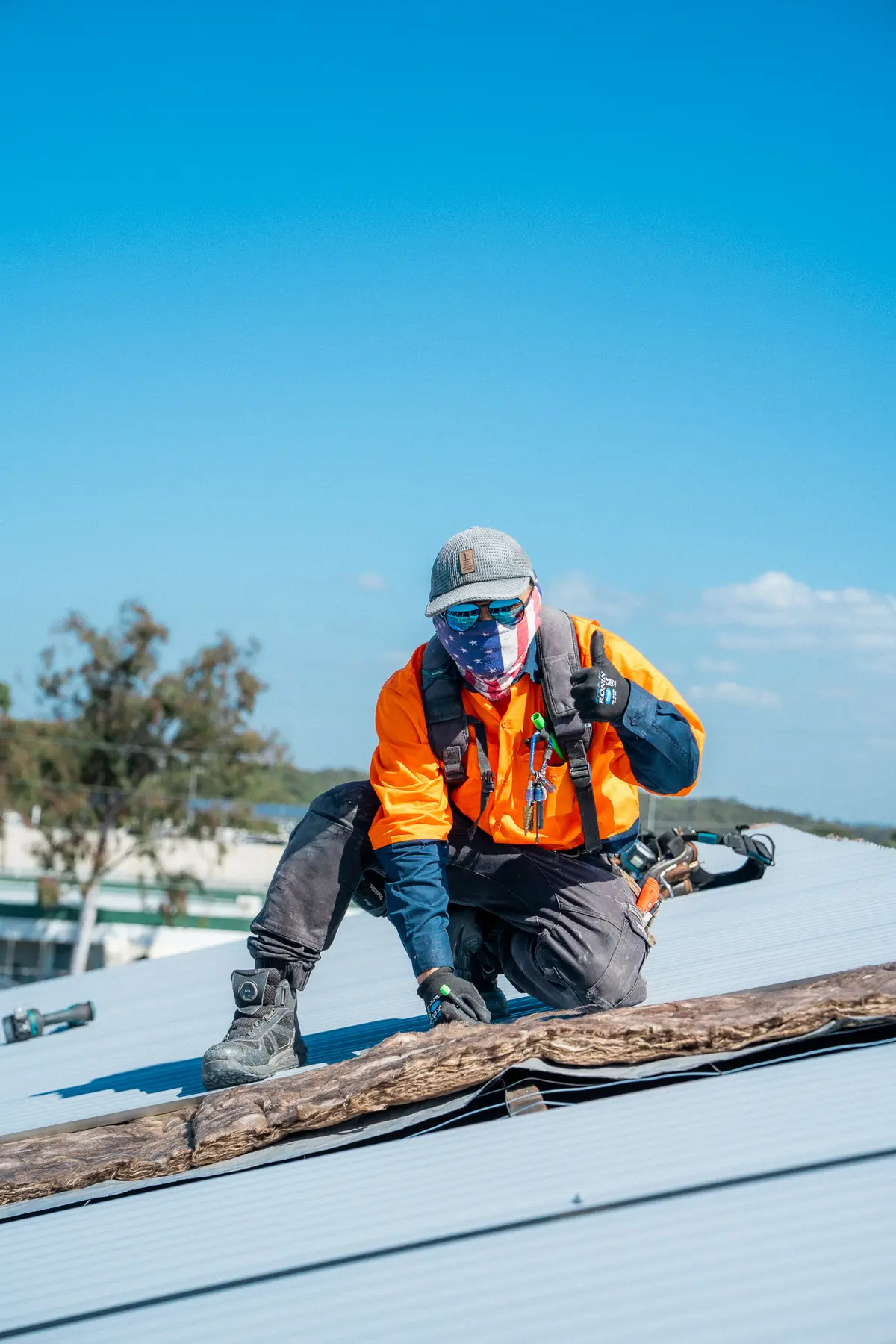 AD Roofing roofer fixing a metal roof with a drill
